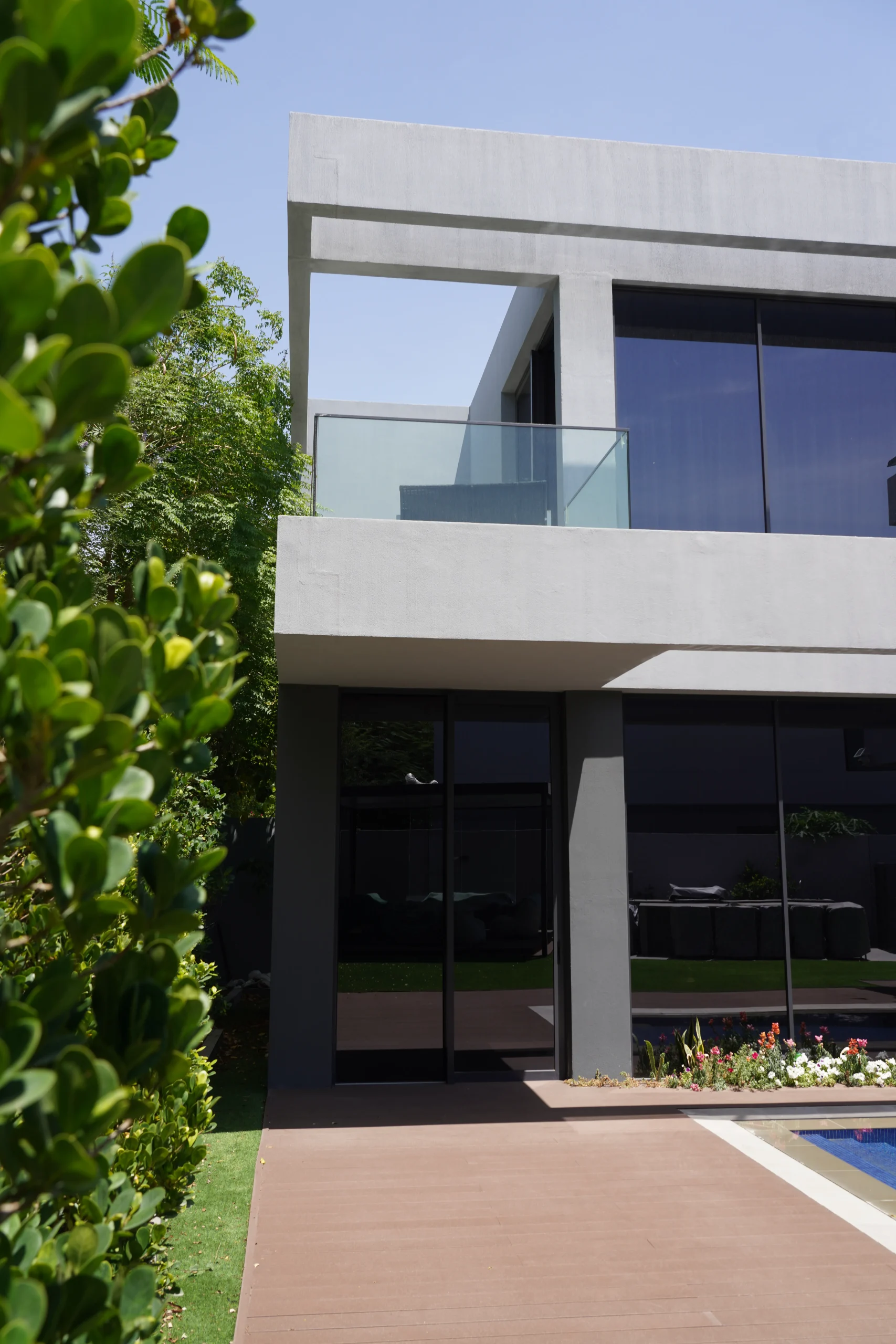 modern minimalist villa exterior with glass balcony UAE